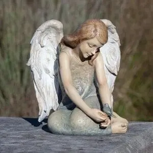 statue angel seated with blue bird