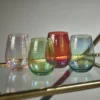 aperitivo stemless all purpose glasses by zodax in multiple colors on a service cart
