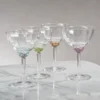 colette optic martini cocktail glass in a variety of colors by zodax on a marble counter top