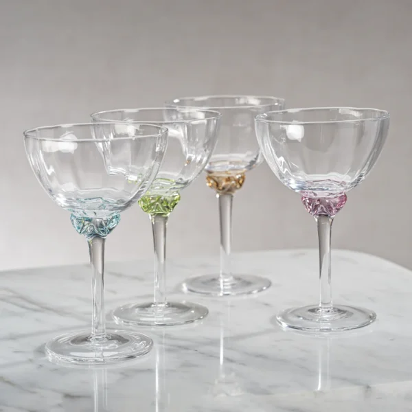 colette optic martini cocktail glass in a variety of colors by zodax on a marble counter top